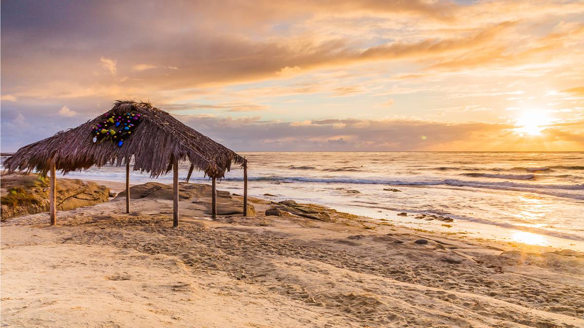 Tiki hut and the sunset over the ocean at Windansea Beach La Jolla in San Diego, California, USA